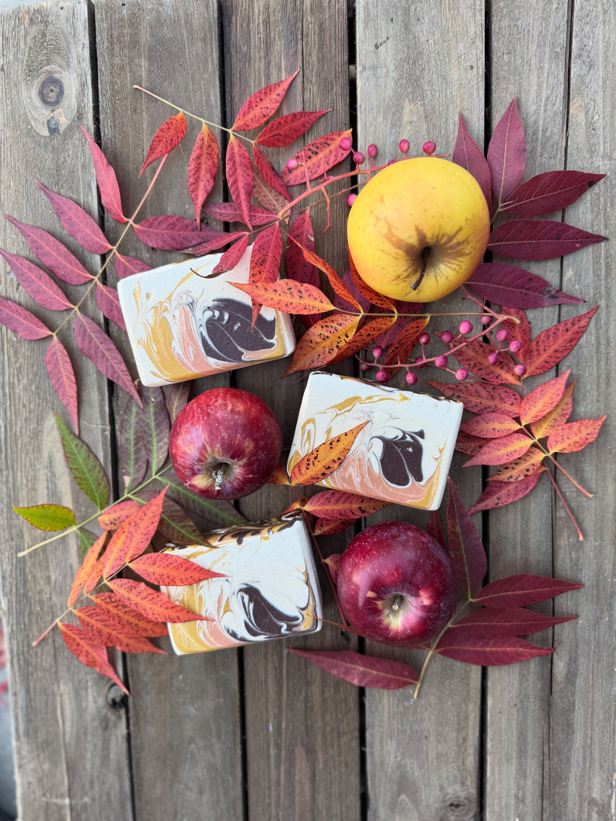Group of three soaps with fall leaves and apples.
