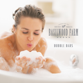 Woman blowing bubbles in bath tub